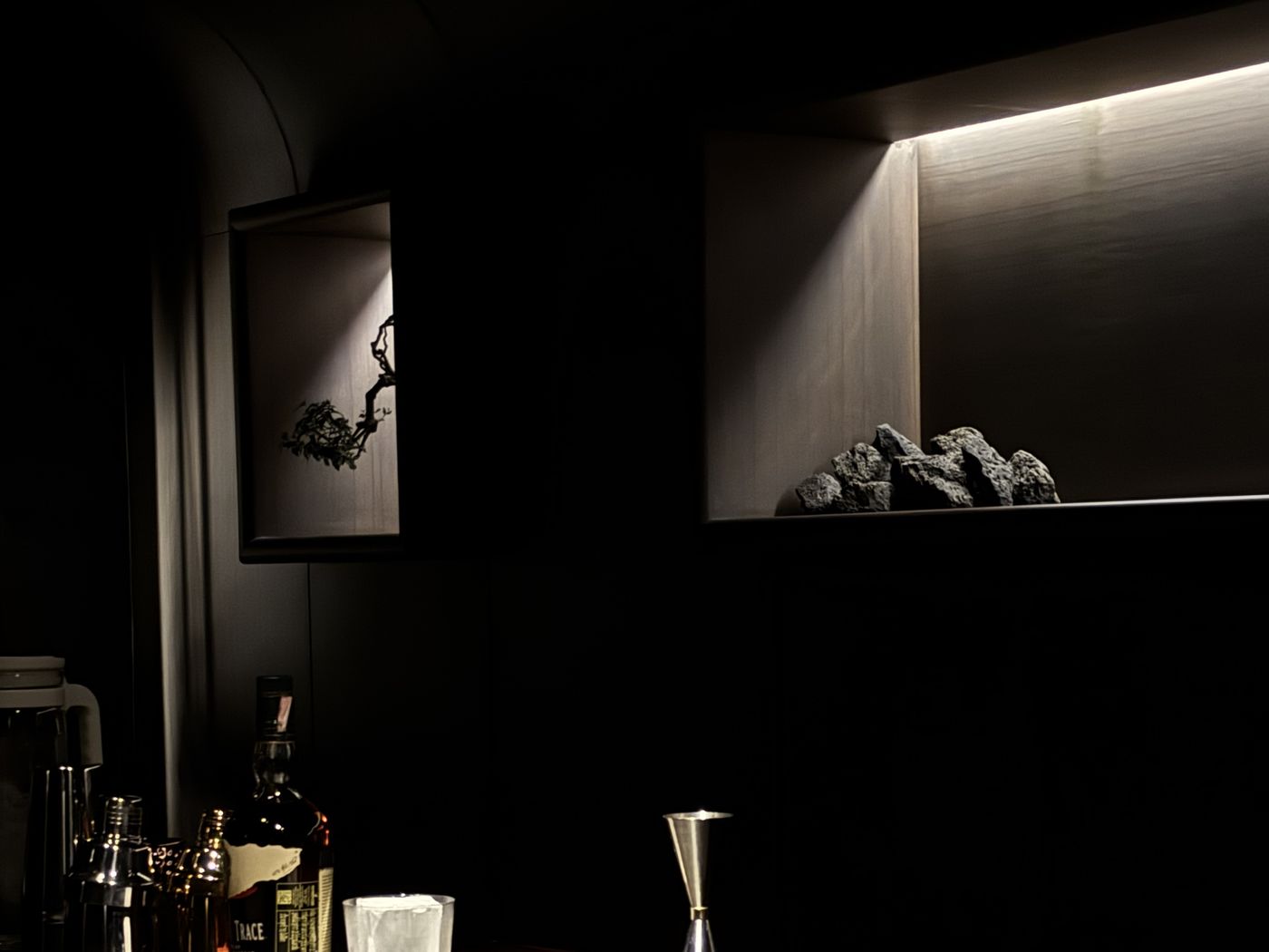 Dark Japandi-style speakeasy bar interior of NORSE.cnx cocktail bar in Santitham, Chiang Mai