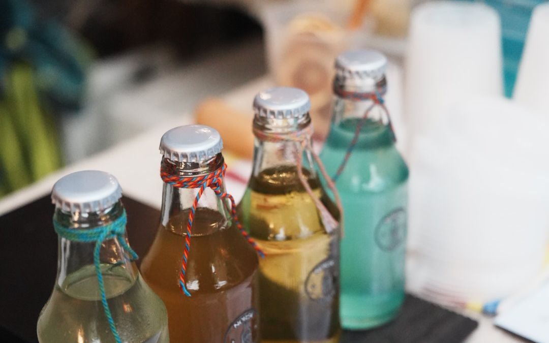 The Four Seasons craft sparkling water tasting set by NORSE sober, served at an event booth with tasting menu